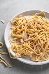 Raw homemade noodles, egg noodles. Home cooking concept.