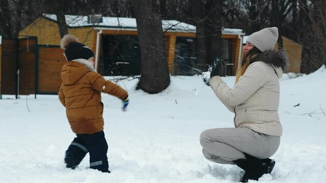 Happy Family Having Fun Playing In The Snow. Winter Entertainment