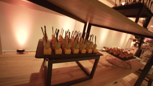 Close-up of canapes on the modern buffet at the party. Decorated party area, food zone