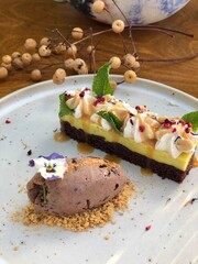 Chocolate cake with mousse on a wooden table with cut pieces on a plate Dessert for the holidays.