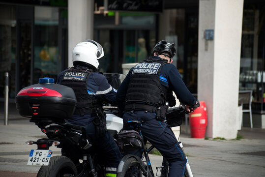Mulhouse - France - 17 March 2022 - Portrait of french municipal policemen and motorbike and bycicle  in the street