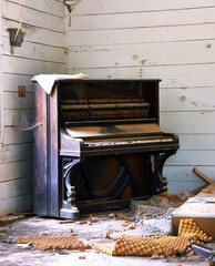 Abandoned Antique Piano Covered in Dust