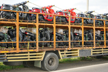 Pati, Indonesia - March, 2022 : Automatic motorcycle transport truck with several floors that can...