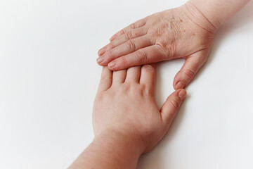 
Two hands of a woman and a girl on a white background