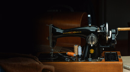 An old retro sewing machine with a place and items for a dressmaker.