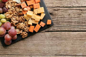 Cheese plate with variety of appetizers on table