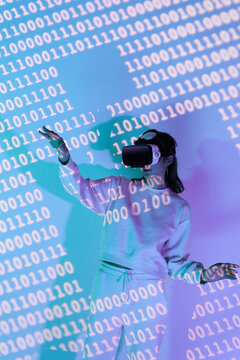 Woman in VR headset near wall with binary code