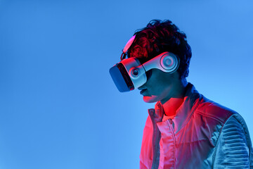 Man in VR headset near blue wall