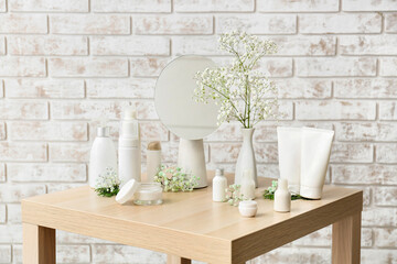 Different cosmetic products on wooden table