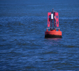red port side channel marker buoy in sea