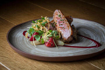 Grilled Duck Breast meat with vegetables on handmade plate, Horizontal