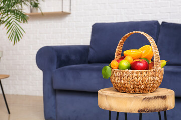 Wicker fruit basket on stool in living room