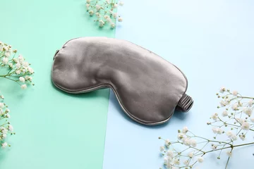 Foto op Canvas Stylish sleep mask and flowers on color background © Pixel-Shot