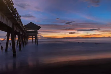 Fotobehang Aubergine Zonsopgangen en zonsondergangen op het strand