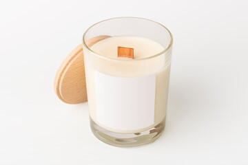 New wax candle in glass with clean label for design. Cozy home decor