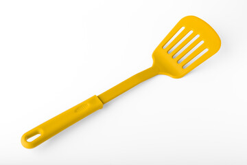 Yellow plastic spatula on a white background. Kitchen tool concept. isolated object