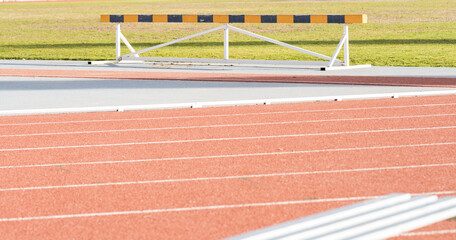 jumping hurdles on athletics track, not people