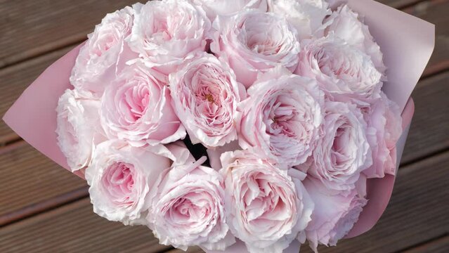 Beautiful pink peony bouquet top view. Blooming roses flowers close-up. Wedding backdrop, Valentine's Day concept. Birthday bunch. Flower closeup