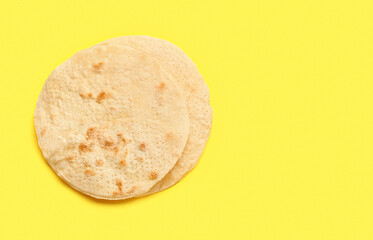 Jewish flatbread matza for Passover on yellow background