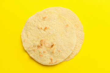 Jewish flatbread matza for Passover on yellow background