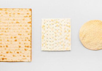 Different Jewish flatbread matza for Passover on light background