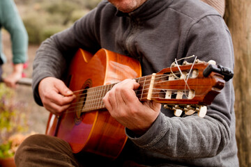Guitar Player Hand or Musician's Hand in F Major Chord on Acoustic Guitar String in Soft Natural...
