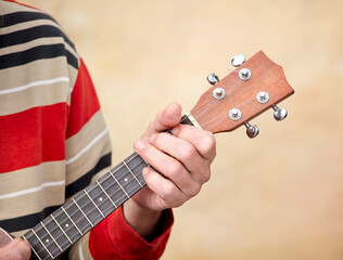 Guitar Player Hand or Musician's Hand in F Major Chord on Acoustic Guitar String in Soft Natural...