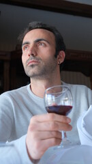 Man drinks wine in minimal luxury restaurant in hotel for summer time. 