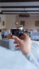 Man drinks wine in minimal luxury restaurant in hotel for summer time. 