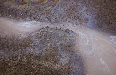 Fuel or oil leaking on asphalt road as texture or background. Environmental pollution concept