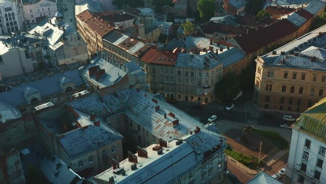Cinematic aerial shot of magnificent street, historic buildings in center of old town Lviv, Ukraine on summer sunrise.