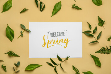 Card with text WELCOME SPRING and plant leaves on color background