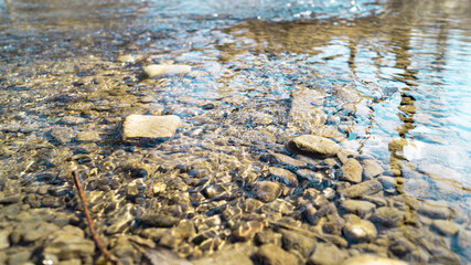 The stones lie in a shallow river with a good current
