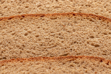 Slices of bread on a brown background. Close up.