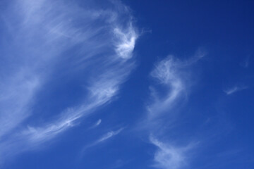 Wispy cloud in a bright blue sky