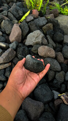Holding a stone with a rock background