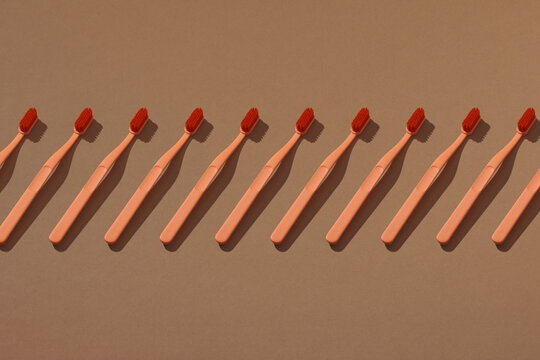 Trendy seamless pattern of toothbrushes on light background