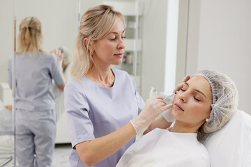 doctor giving face lifting injection