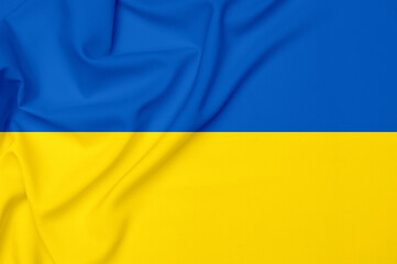 Smooth elegant tissue abstract background in color of ukrainian flag. Textile background. Cloth wallpaper. Graphics design element