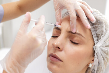 doctor giving face lifting injection