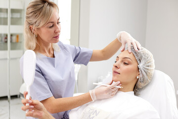 Beautician examines the patient