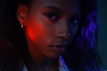 portrait of beautiful black woman, female face in neon light 