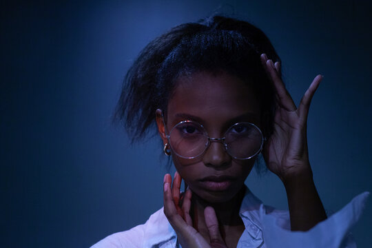 young beautiful black woman wearing glasses in studio