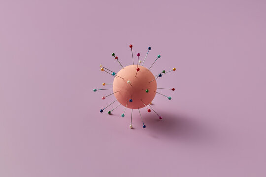 Ball pierced with colorful sewing pins