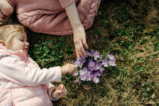 Mother and child touching spring flowers