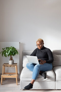 work from home, woman with laptop sitting on the couch