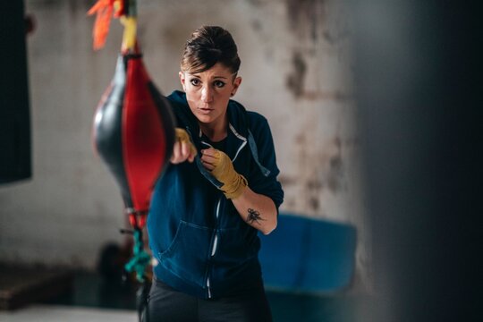 Female boxer training in gym