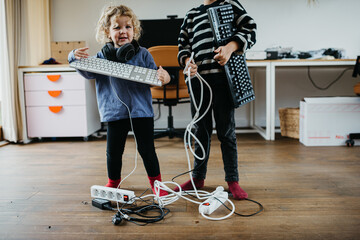 Kids playing with electronic devices at home