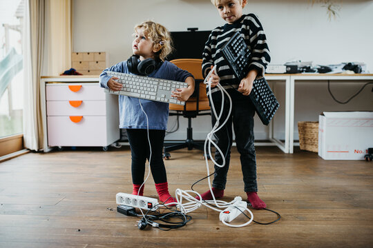 Kids playing with electronic devices at home
