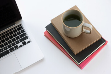 Laptop and coffee on white desk